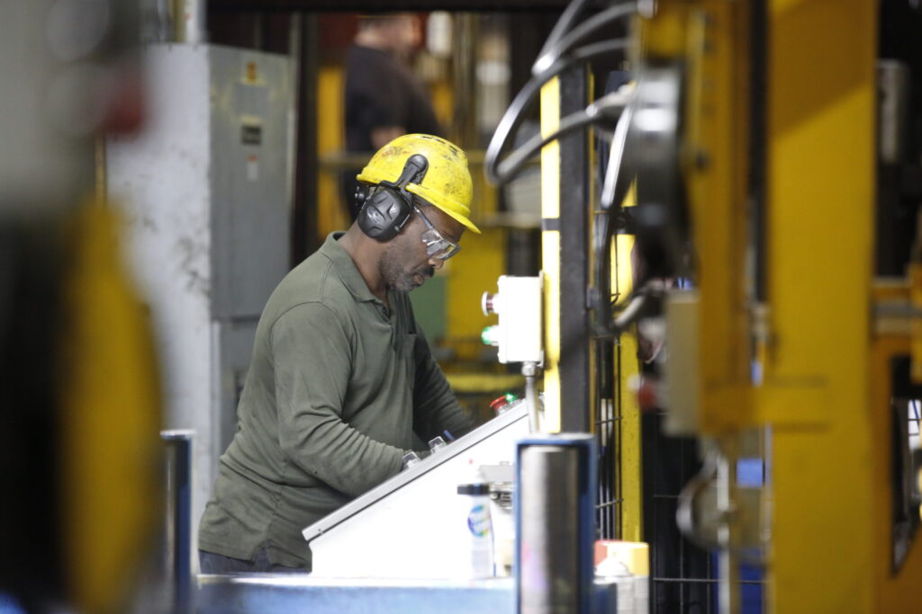 Bull Moose Employee at plants with Yellow hat and ear piece